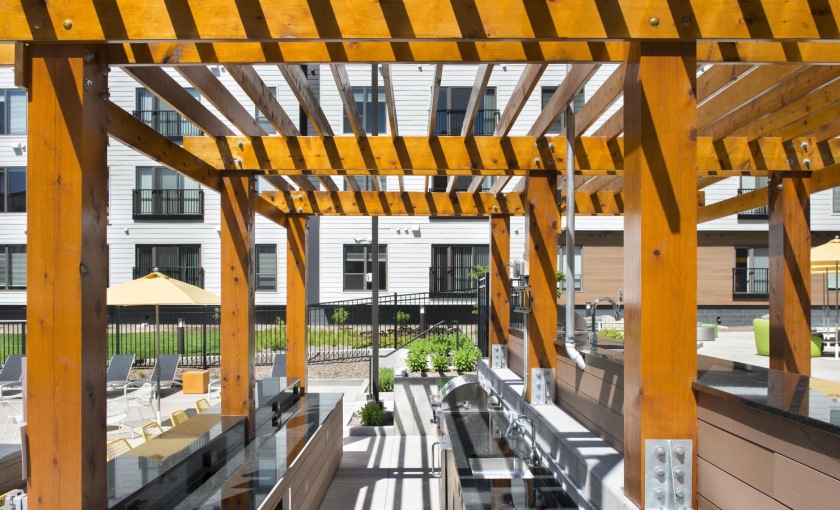 a grill area with a covered gazebo