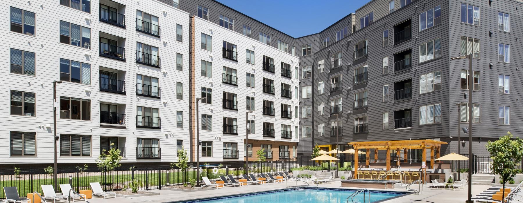 a swimming pool in front of a large building