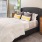a bedroom with a bed with a white bed spread