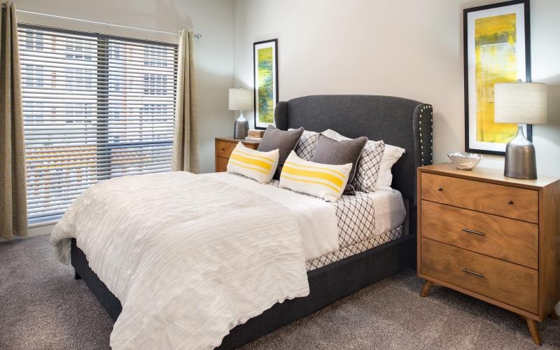a bedroom with a bed with a white bed spread