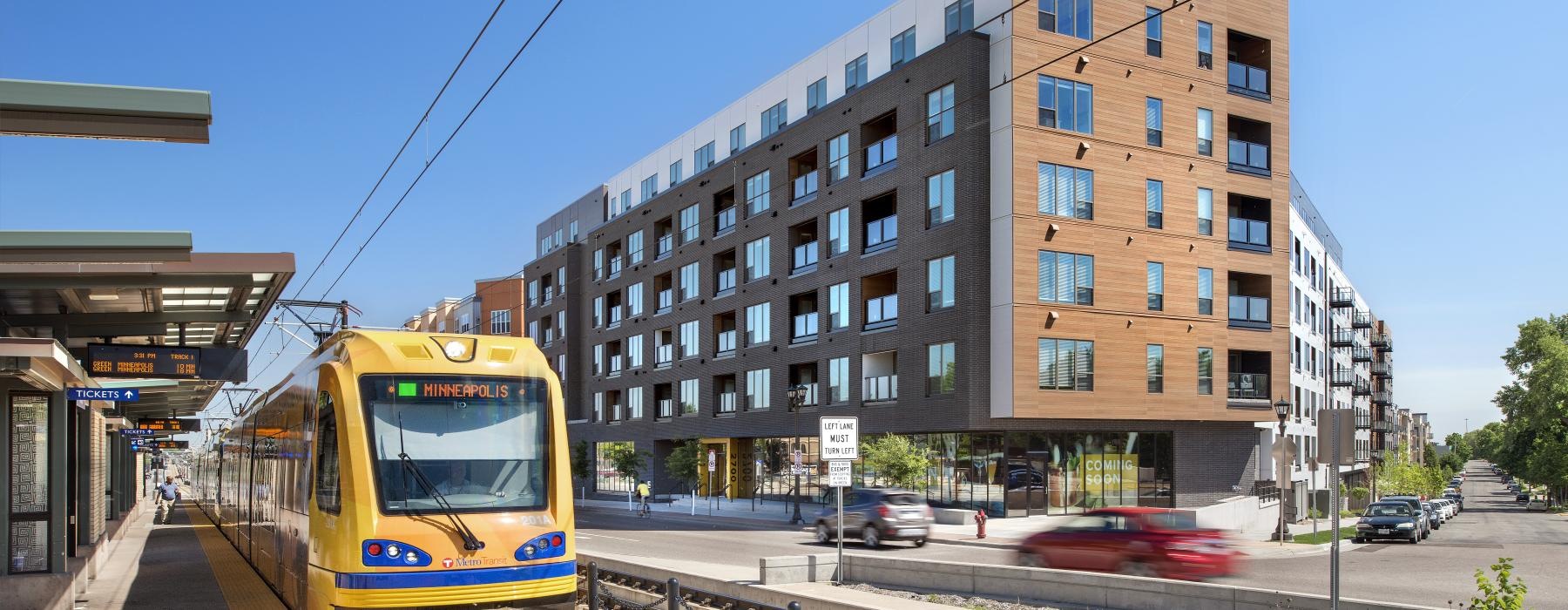 a train on the railway tracks next to a building